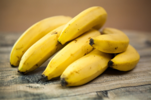 A bunch of bananas on a wooden table