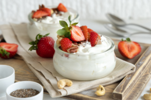 yogurt in a glass bowl with strawberries on top