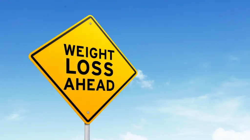 how to lose weight with adhd: yellow sign against blus sky that reads "weight loss ahead"